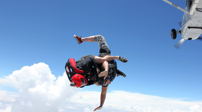 Two skydivers jump from an air