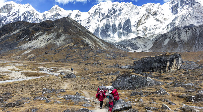 Porters with heavy load crossing Cho La Pass