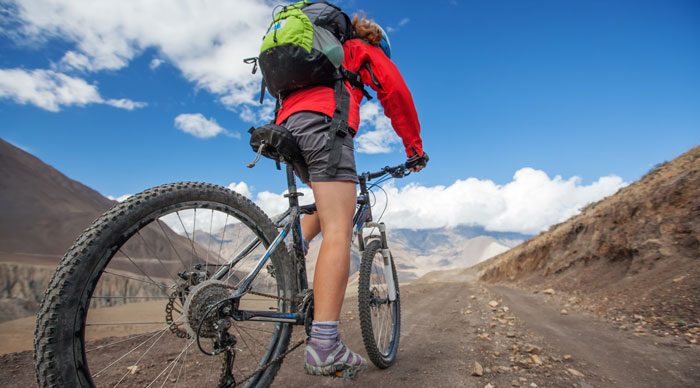 Girl cycling at the Road in Himalaya