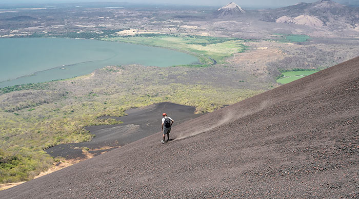 A young man doing volcano boarding in Nicaragua